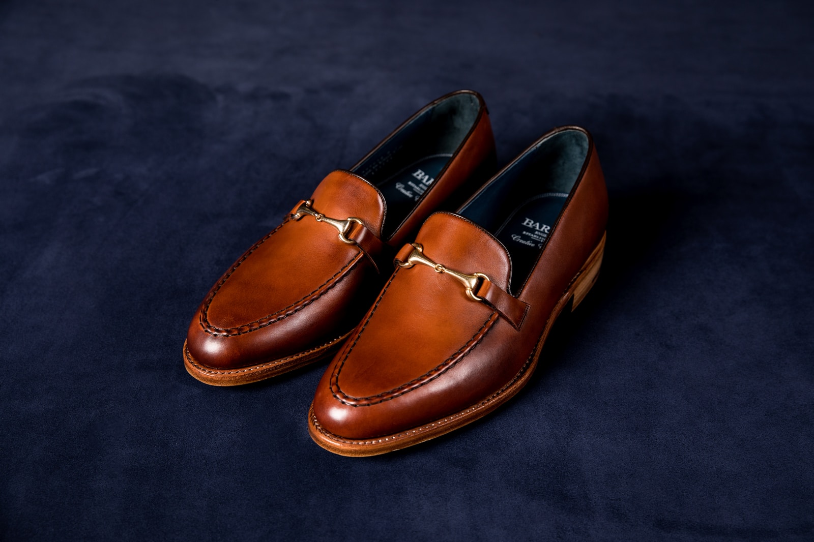 Photo by Noah Smith brown leather loafers on blue textile